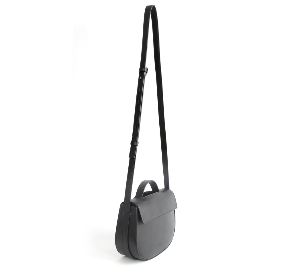 Eco vegan leather crossbody bag by Sydney Brown. Timeless, classic and modern. Shoulder or crossbody strap angle view.