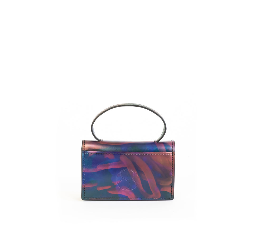 Microbag wallet with handle and an interior and exterior card slot. Iridescent Print faux-leather. Back