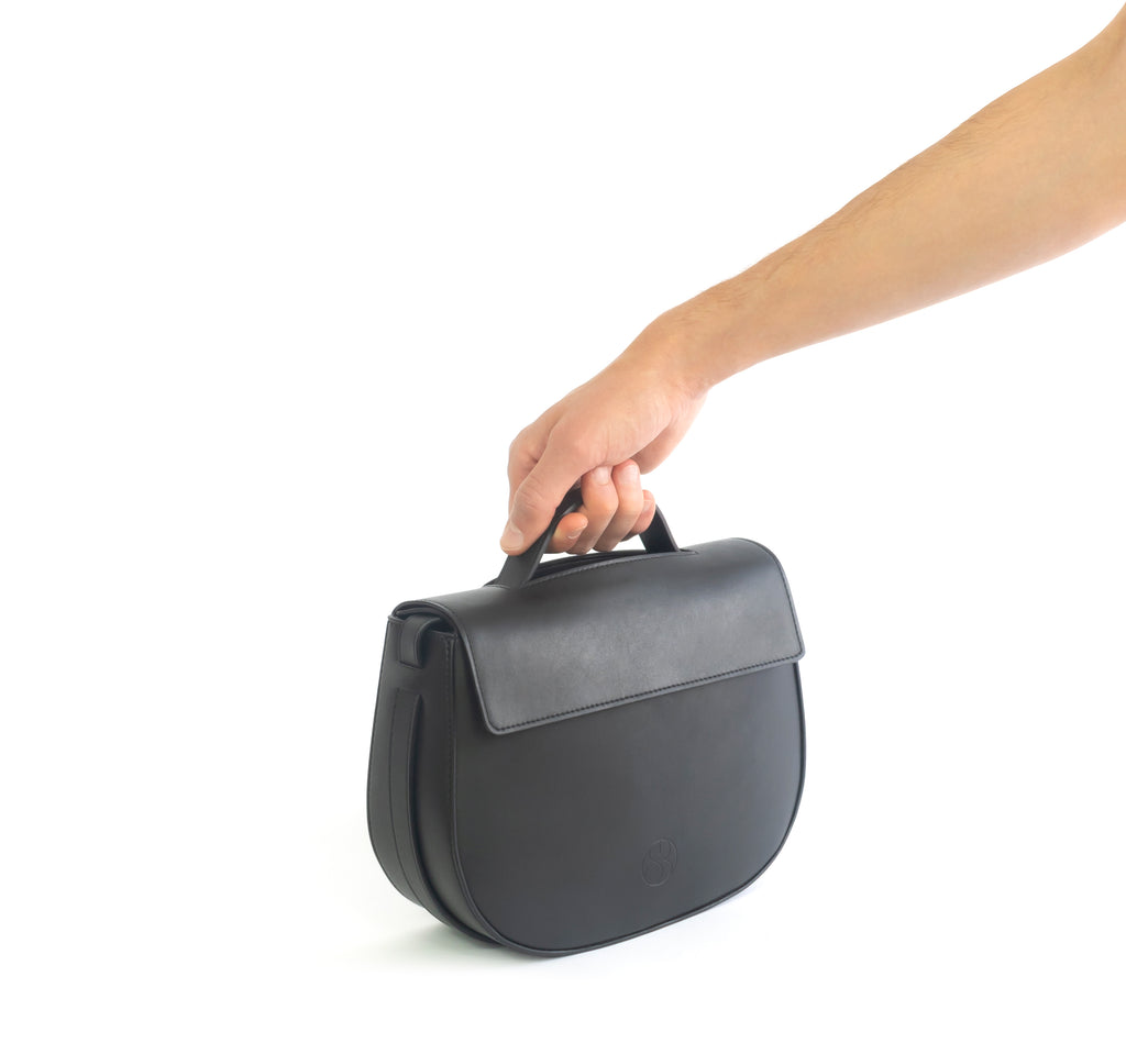 Eco vegan leather crossbody bag by Sydney Brown. Timeless, classic and modern.  Hand view