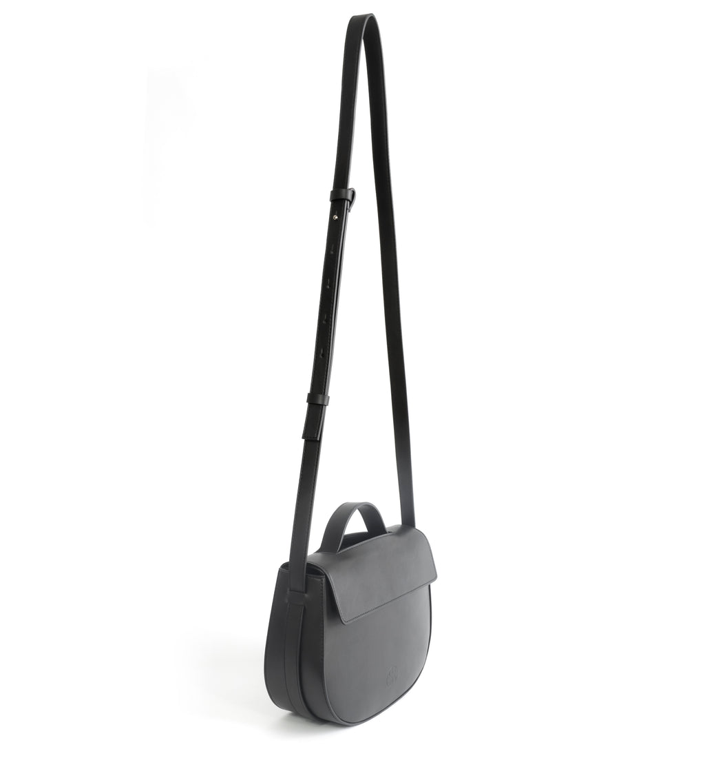 Eco vegan leather crossbody bag by Sydney Brown. Timeless, classic and modern. Shoulder or crossbody strap angle view.