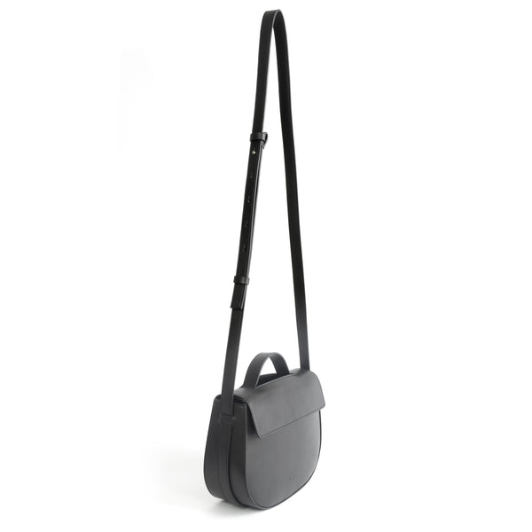 Eco vegan leather crossbody bag by Sydney Brown. Timeless, classic and modern. Shoulder or crossbody strap angle view.