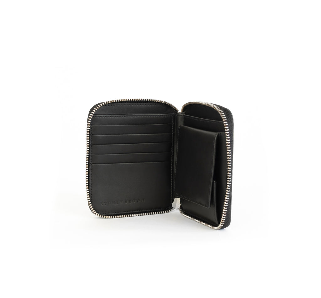 Unisex zipped wallet with inside coin pouch and card slots. Black Emboss faux-leather. Inside