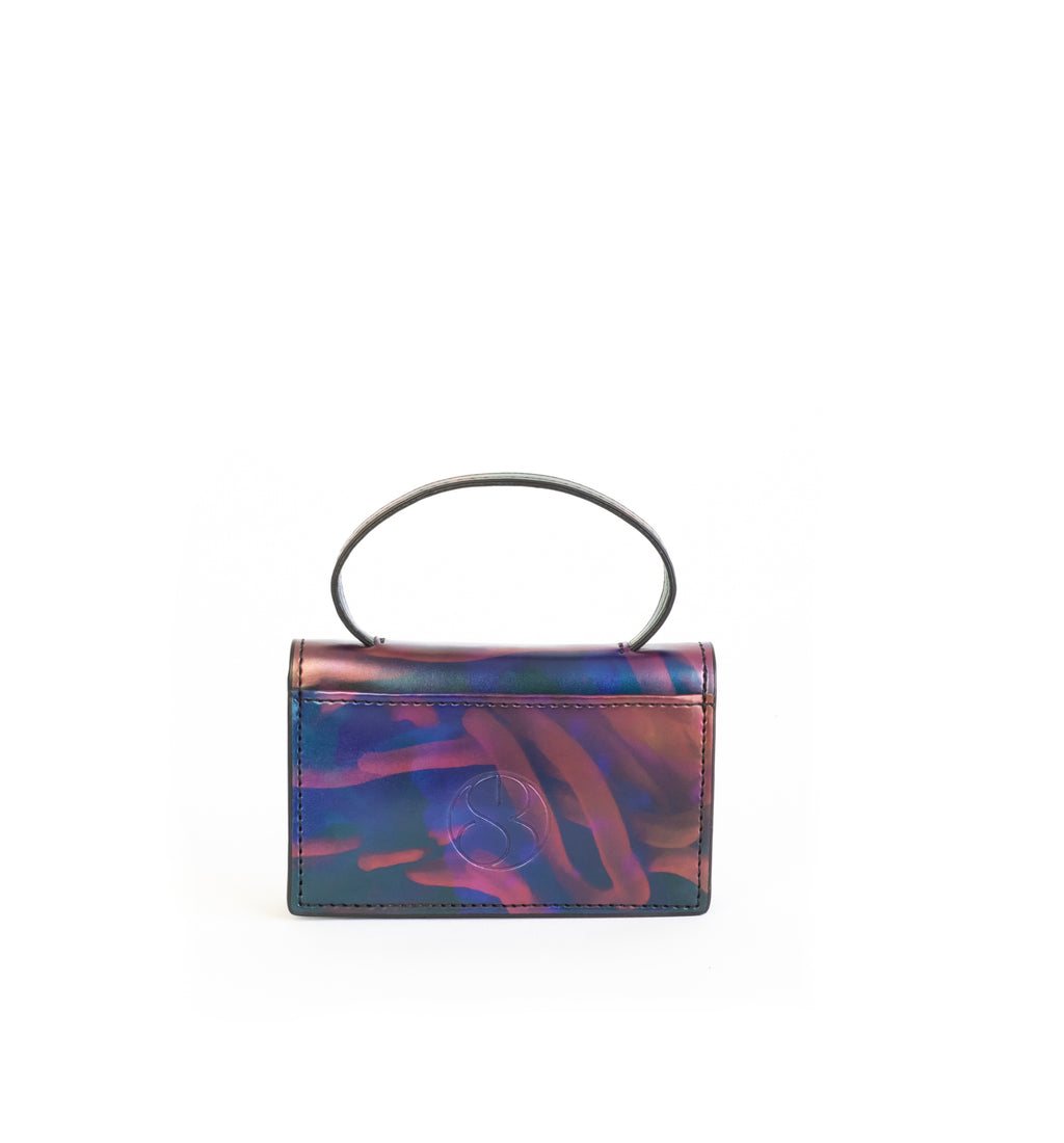 Microbag wallet with handle and an interior and exterior card slot. Iridescent Print faux-leather. Back
