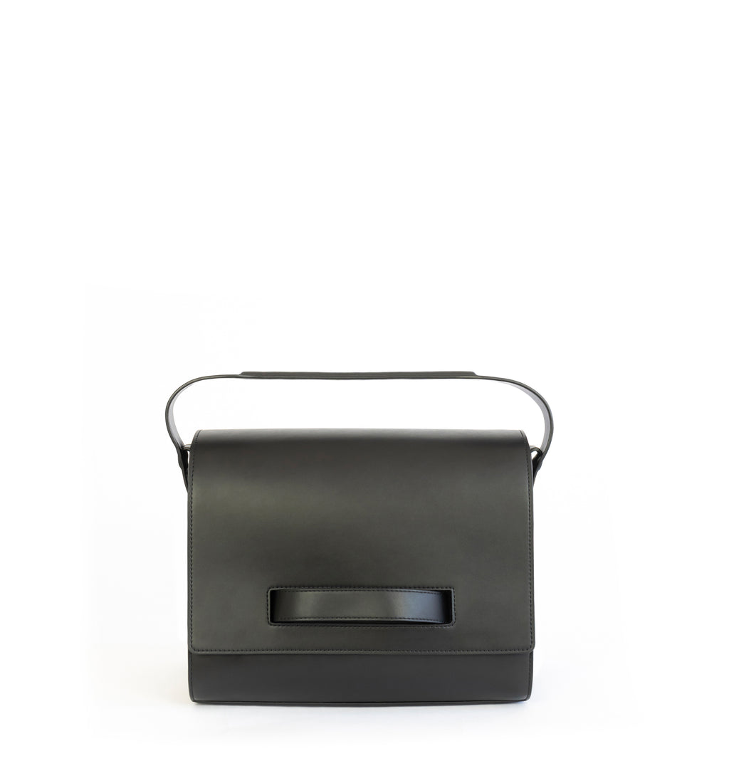 Black eco vegan leather barrel shoulder bag by Sydney Brown. Timeless, classic and modern. Front view