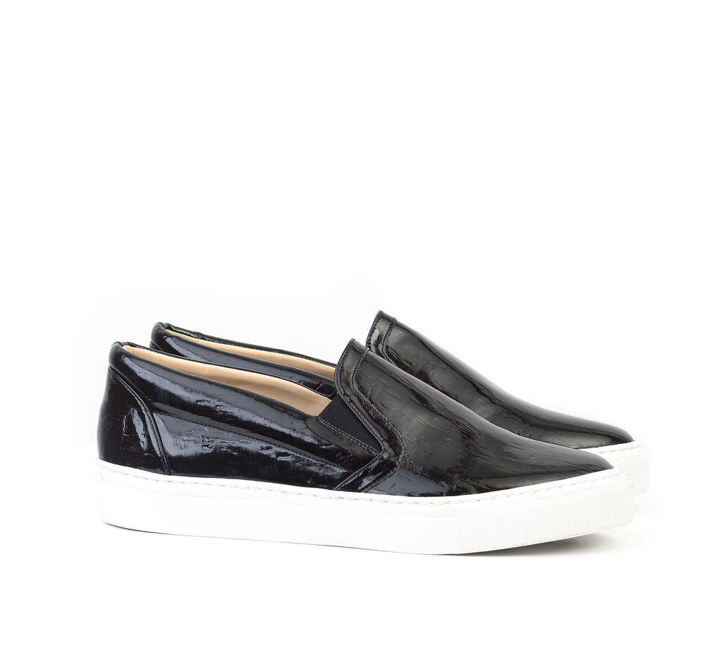 Unisex Slip-on in black patent cork, black side elastics and white rubber sole.