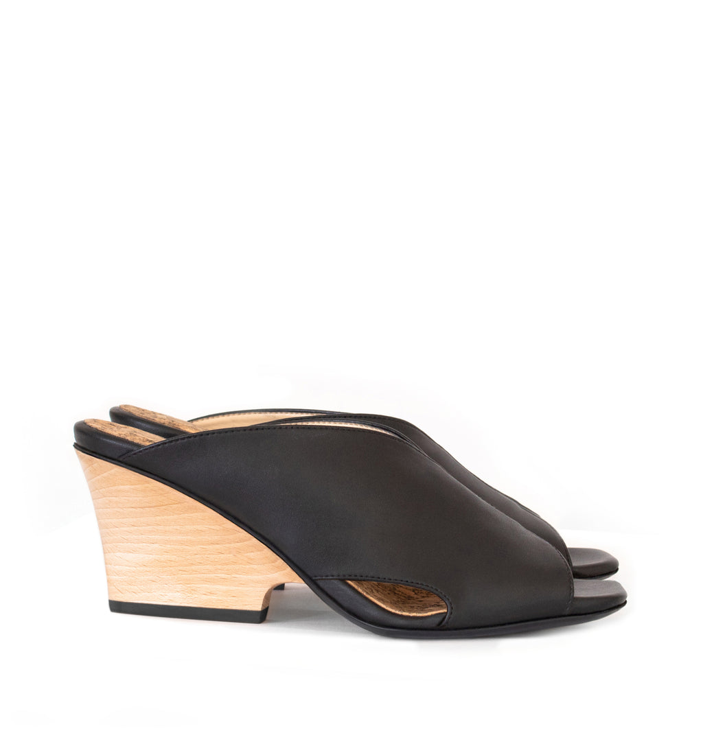 Black faux-leather mule slide with a curved design high heel in light brown wood.