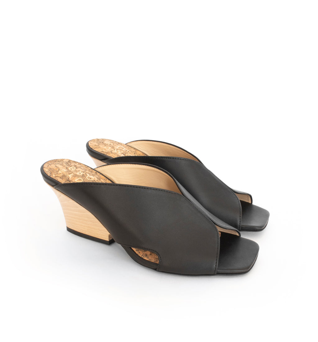 Black faux-leather mule slide with a curved design high heel in light brown wood.