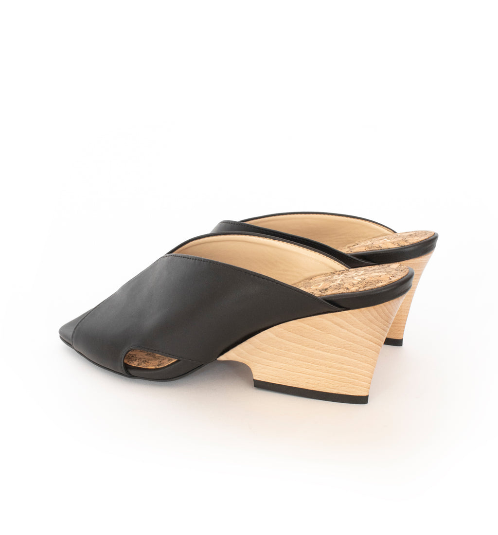 Black faux-leather mule slide with a curved design high heel in light brown wood.