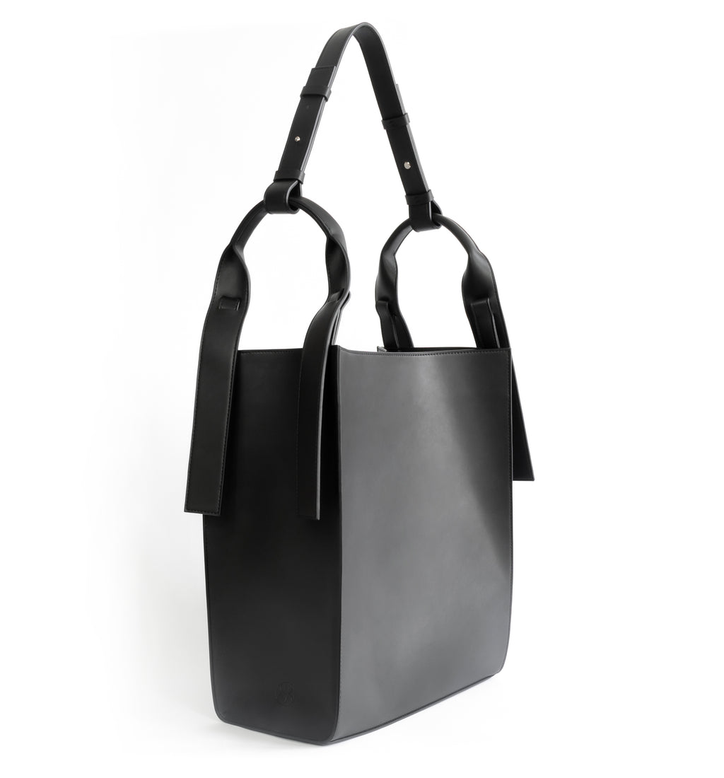 Black eco vegan leather tote shoulder bag by Sydney Brown. Timeless, classic and modern.  Angle View.