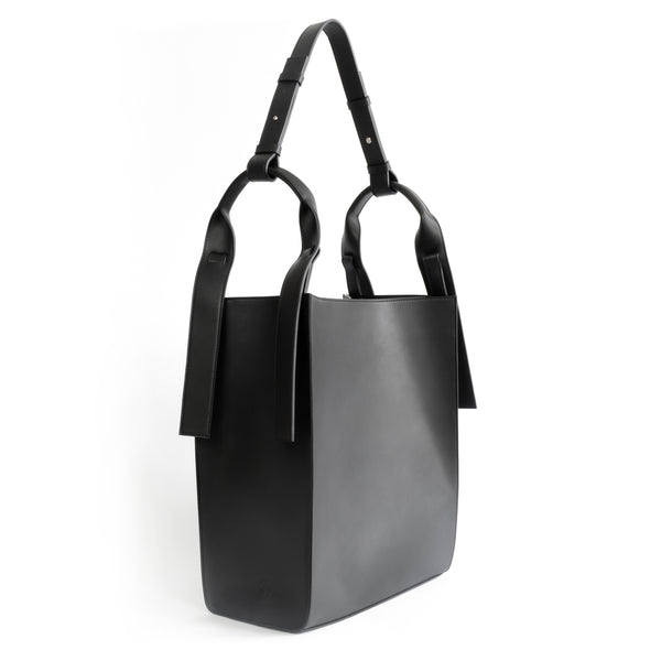 Black eco vegan leather tote shoulder bag by Sydney Brown. Timeless, classic and modern.  Angle View.
