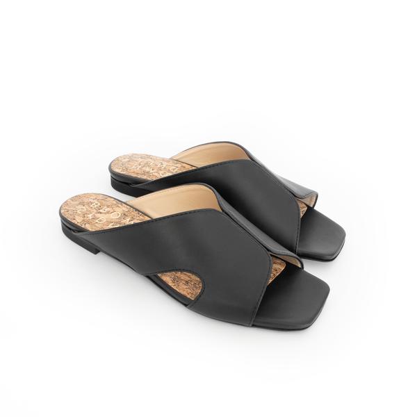 Black faux-leather slide with a black flat sole.